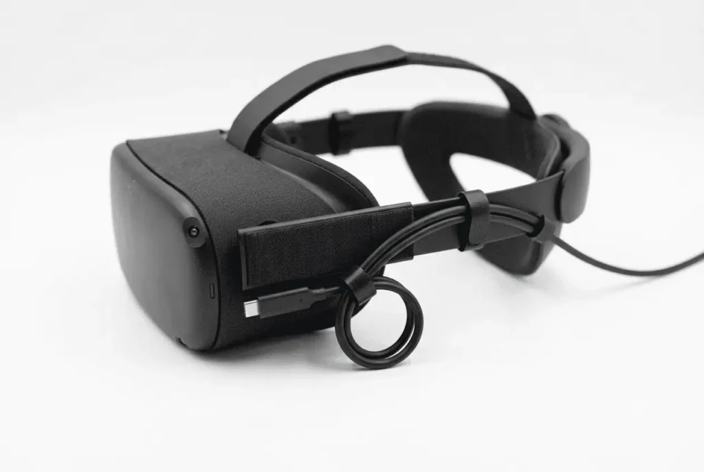 Quest Link cable secured to a VR headset head strap with Velcro ties